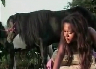Tanned slut is sucking a horse