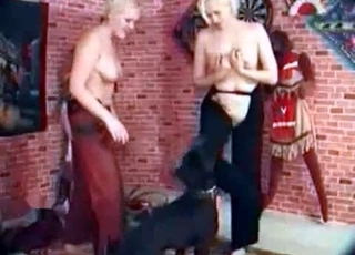 Two girls and their black dog