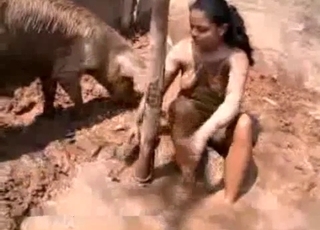 Dirt-covered Latina stalks a kinky pig